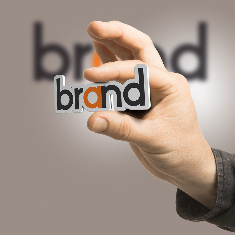brand identity - One hand holding the word brand over a beige background. Branding concept. The image is a composition between 2D illustration, 3D rendering and photography - borzo delivery