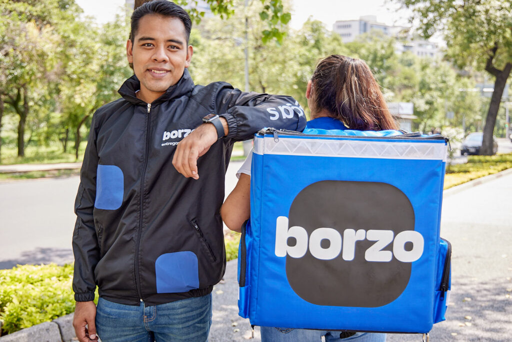 business values ​​directly affect the results of your business - man and woman couriers stand outside - borzo delivery
